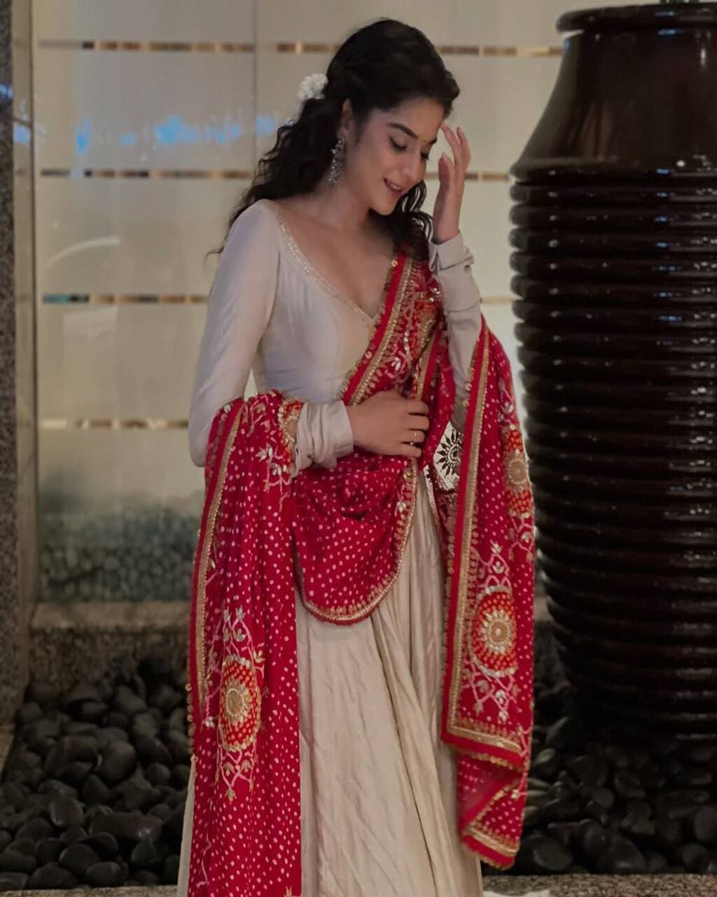 Cream designer gown with red bandhani dupatta – perfect wedding and festive outfit