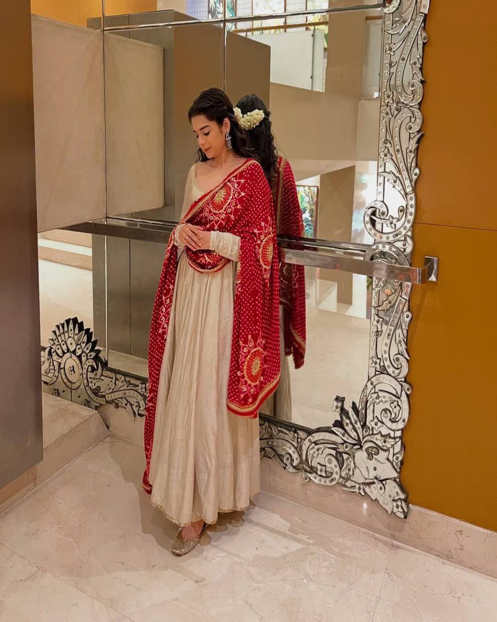 Elegant cream chinon gown for women with printed red bandhani dupatta for weddings