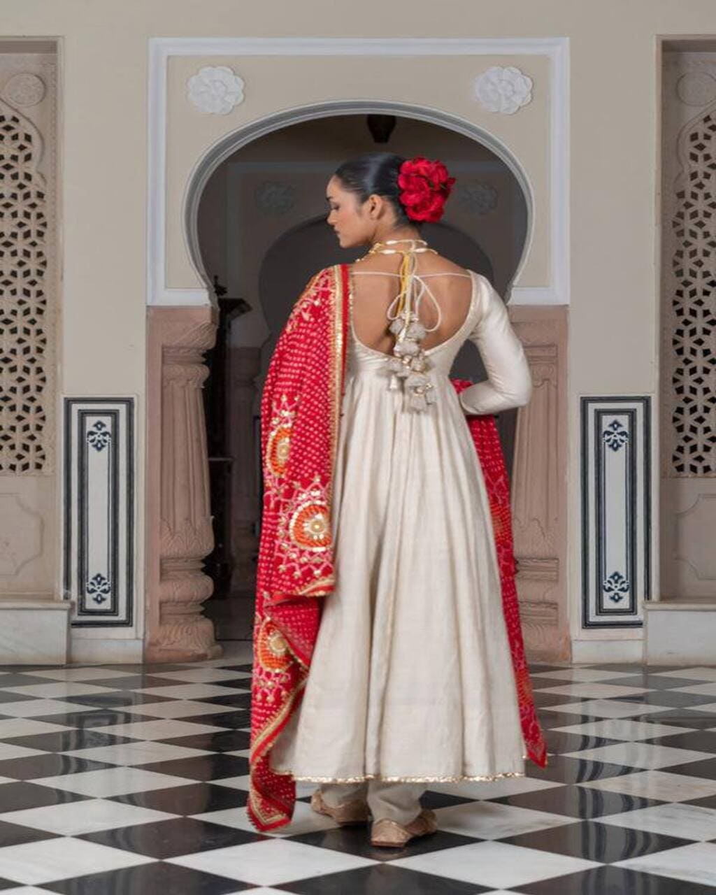Stylish cream wedding gown with lace work and red bandhani dupatta for occasions
