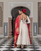 Stylish cream wedding gown with lace work and red bandhani dupatta for occasions