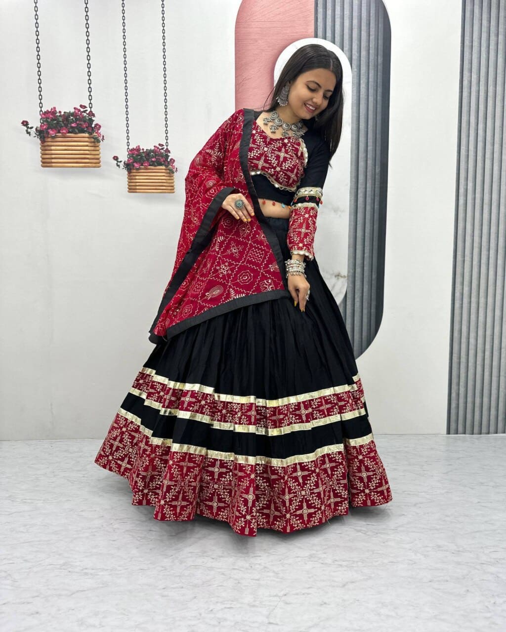 Traditional black lehenga choli with red dupatta and embroidered details for Navratri