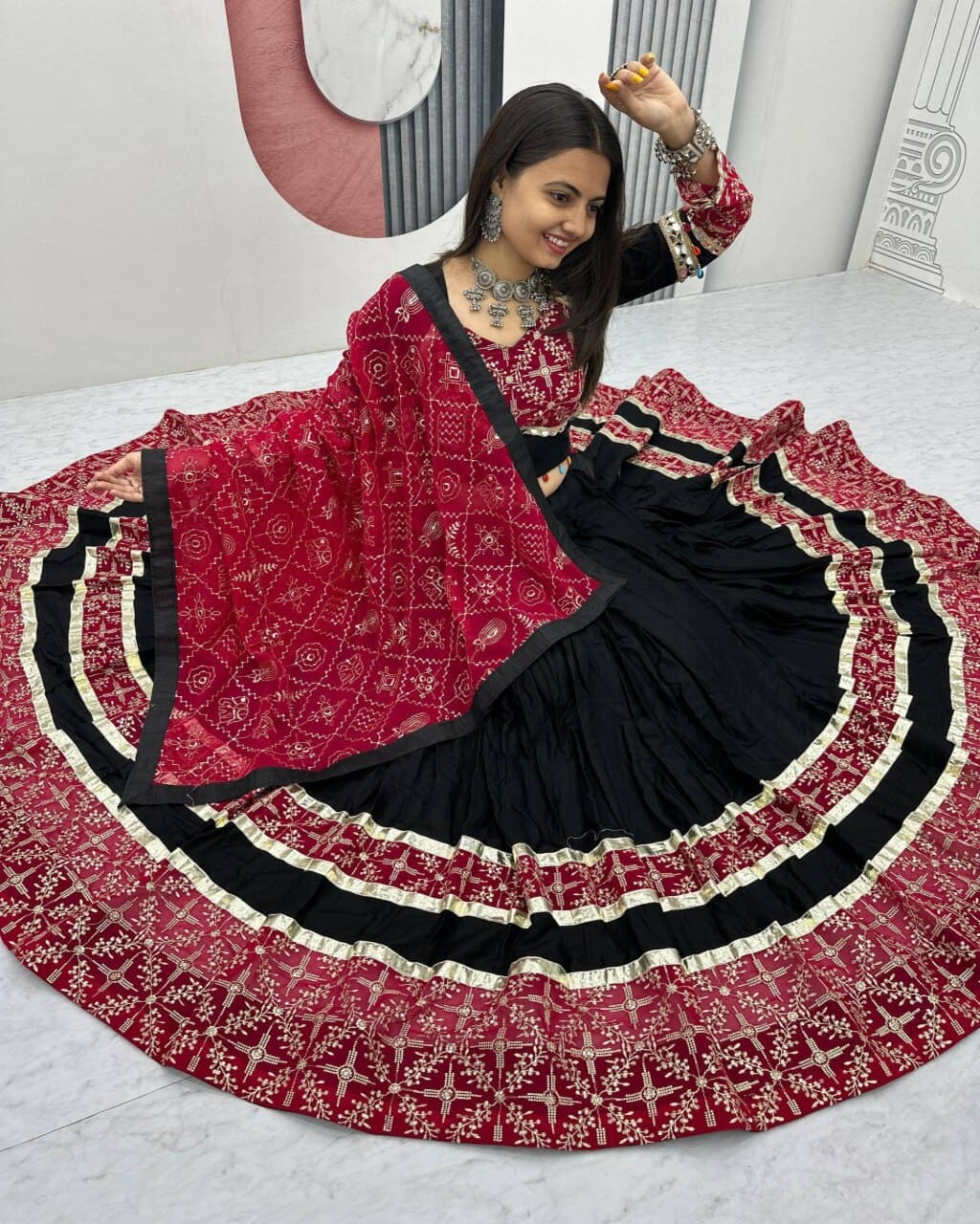 Festive black lehenga choli for women with red dupatta and heavy embroidered design