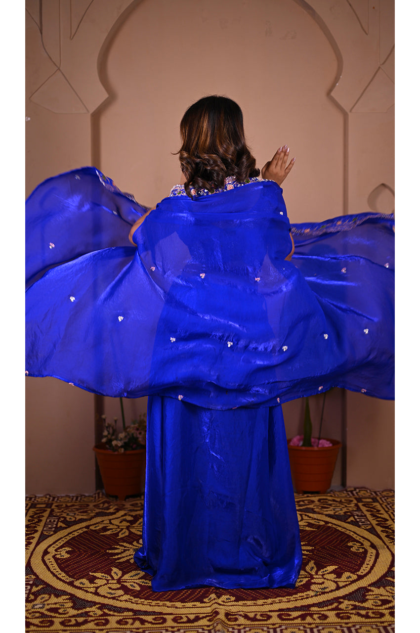 Blue indo western lehenga set back full look showing complete outfit with shrug and lehenga for festive wear