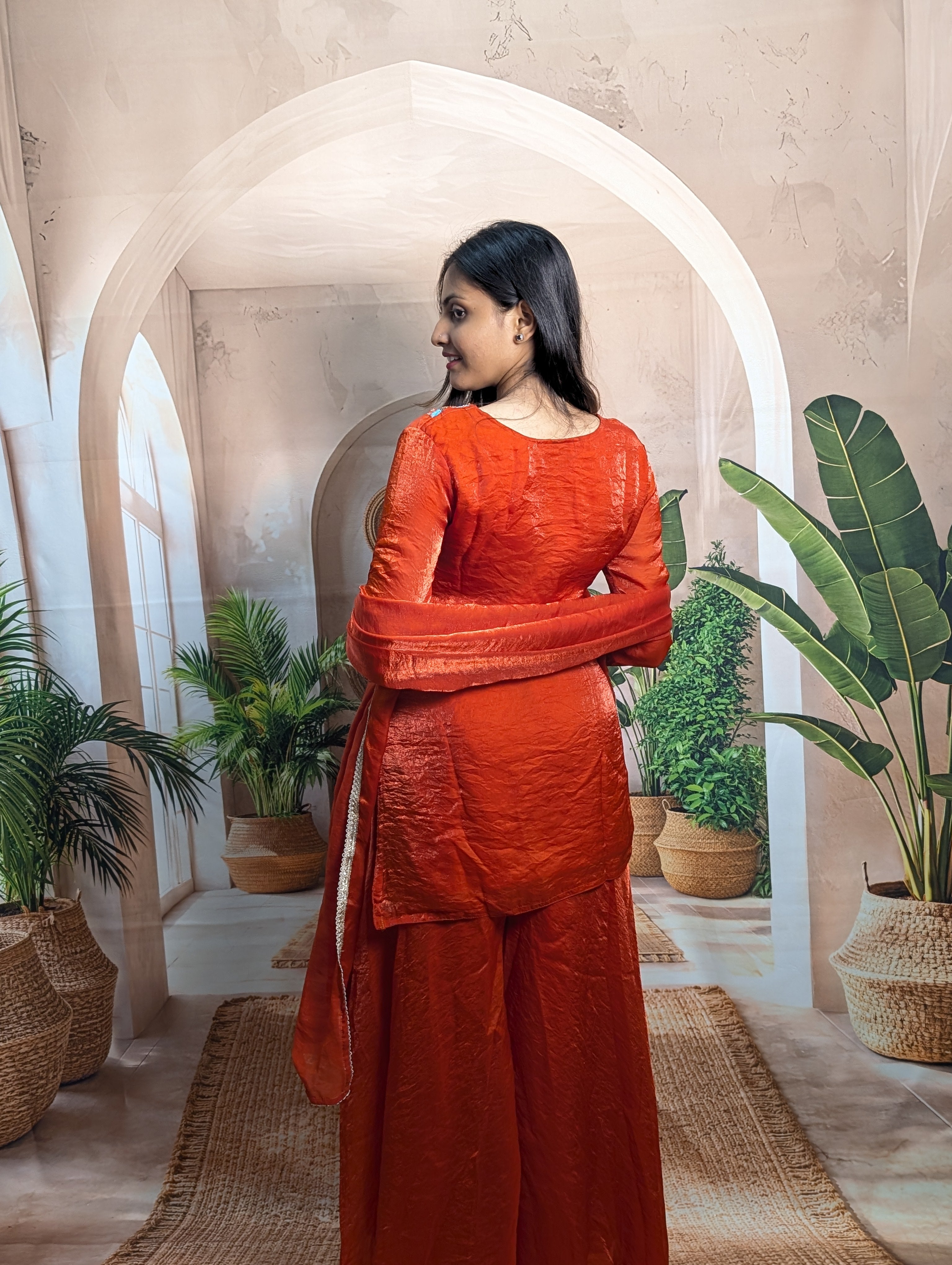 Designer rust orange heavy beaded wedding palazzo set back view for women with graceful festive fashion look