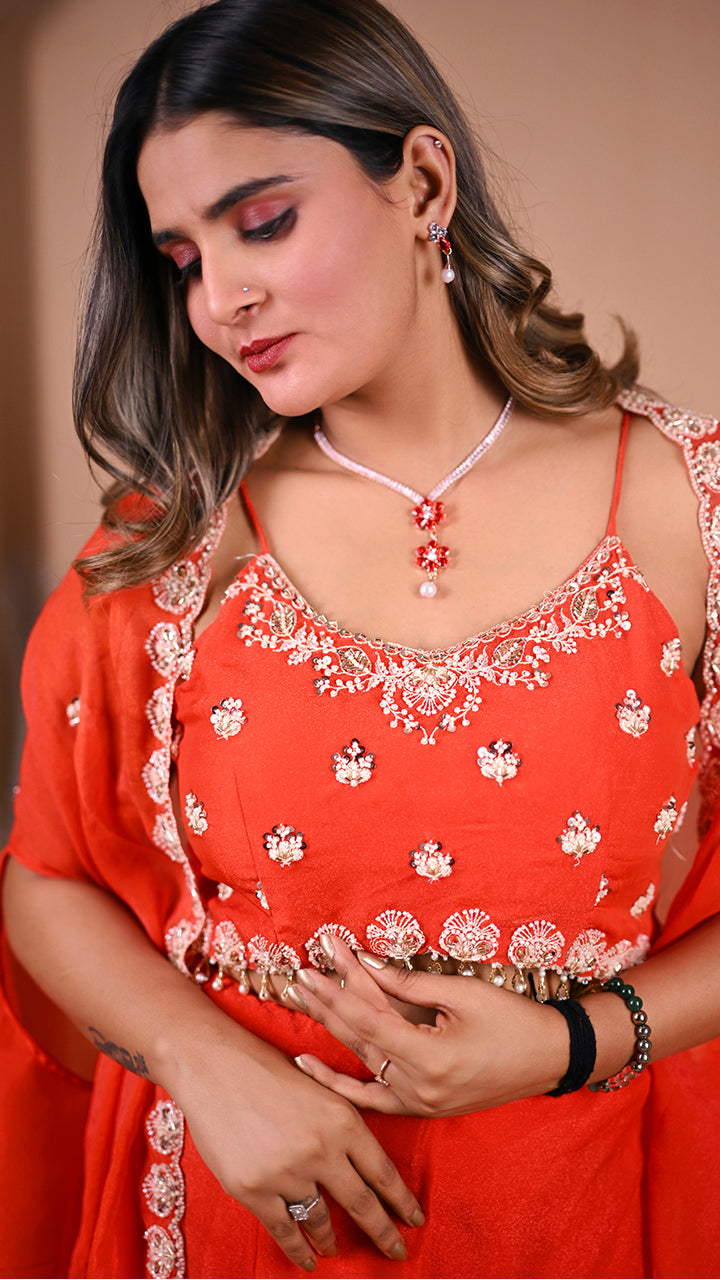 Stylish orange indo western outfit side view with pleated skirt