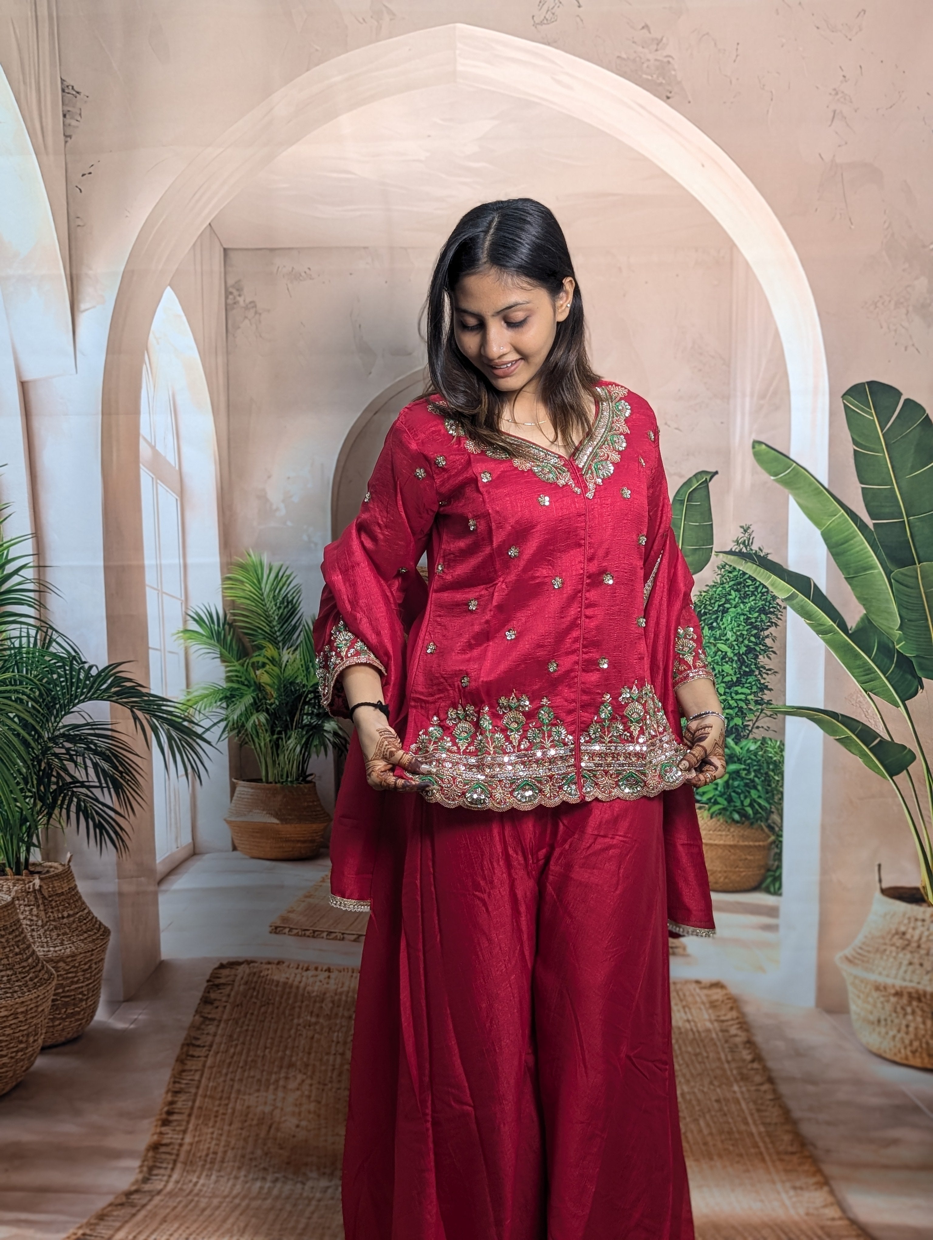 Women wearing Premium Rama Pink embroidered palazzo suit with elegant festive ethnic fashion look