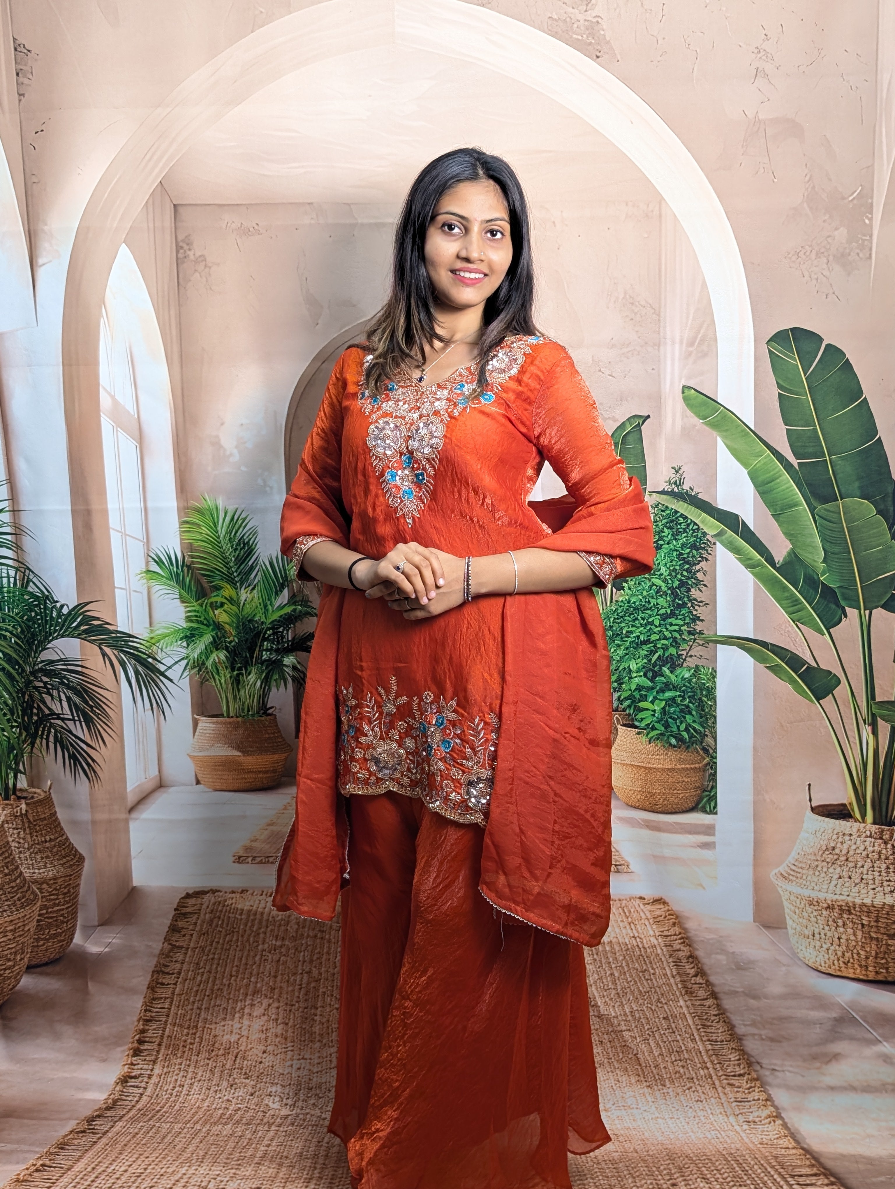 Elegant model wearing designer rust orange heavy beaded wedding palazzo set in premium Fendy fabric for festive wear